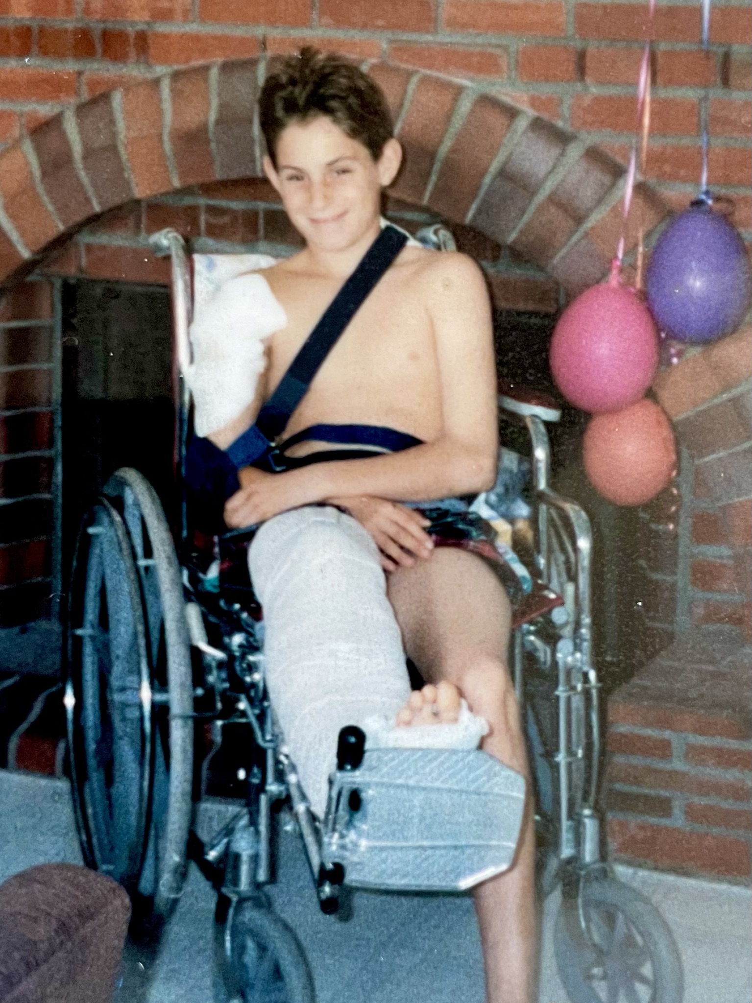 Jeremy Sigal in a wheelchair after being hit by a car at age 12